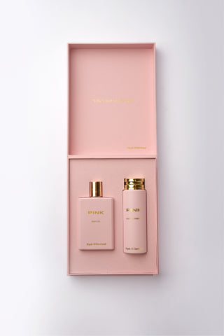 Pink perfume set with two bottles and a box on a light gray background